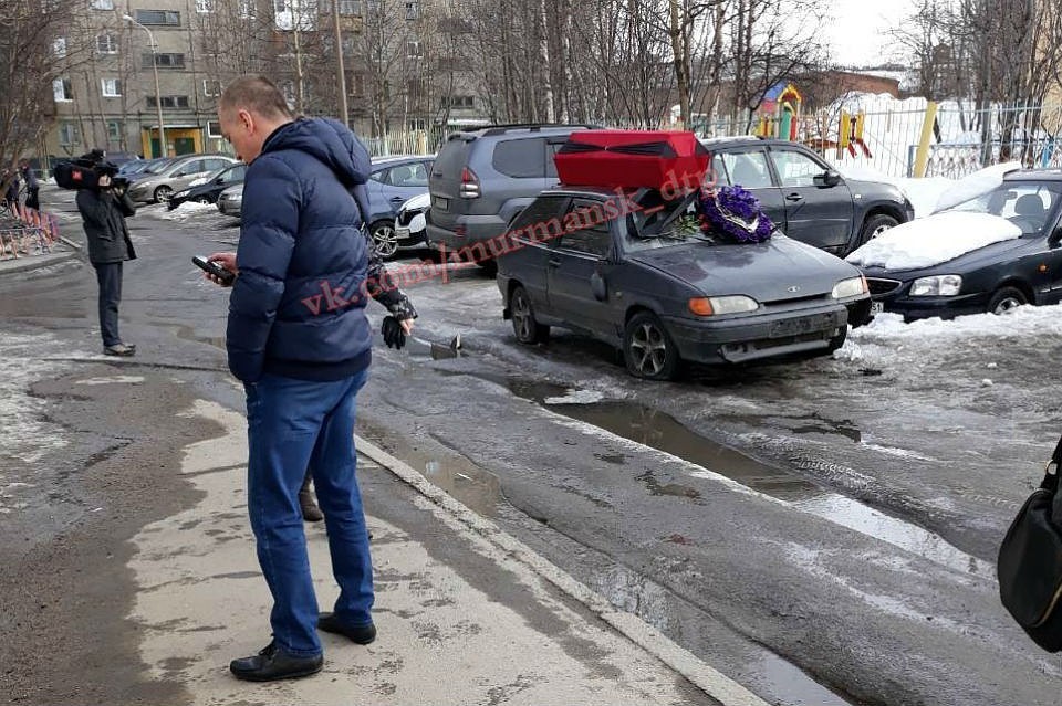 Мужчины в балаклавах поставили гроб на машину, заодно проколов шины. Фото: vk.com/murmansk_dtp